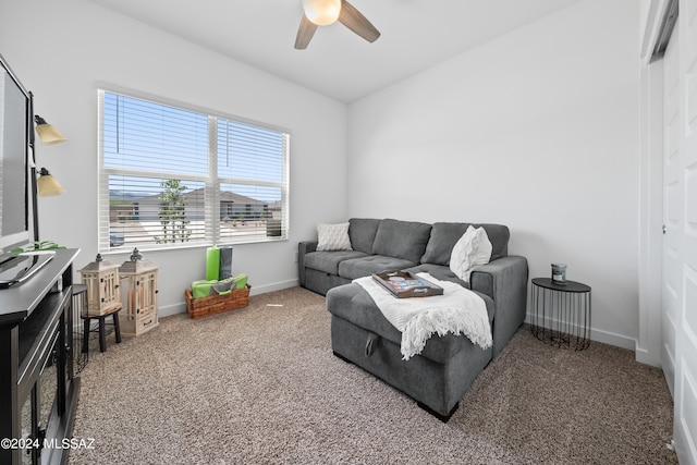 carpeted living room with ceiling fan