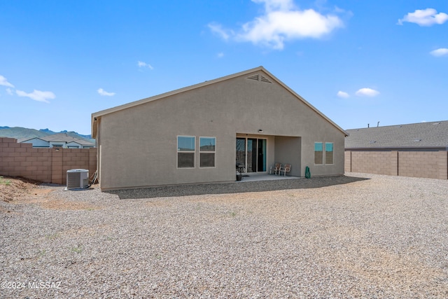 back of property featuring central AC unit and a patio