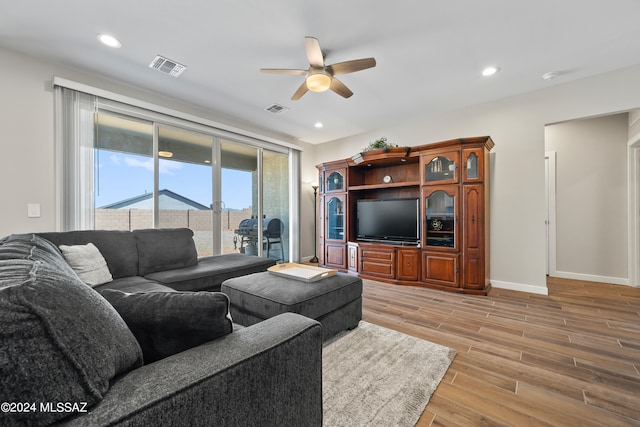 living room featuring ceiling fan and light hardwood / wood-style flooring