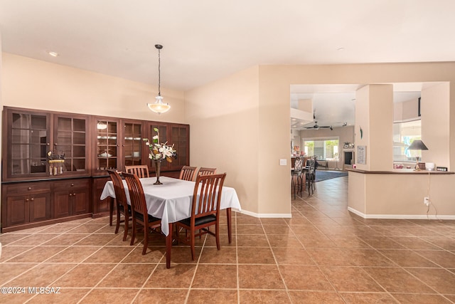 dining space with tile patterned flooring and ceiling fan