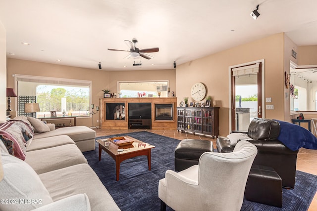 living room with ceiling fan and tile patterned floors