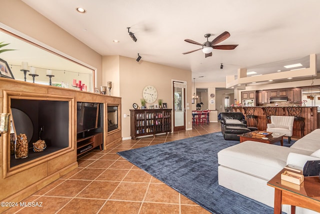 living room featuring dark tile patterned flooring and ceiling fan