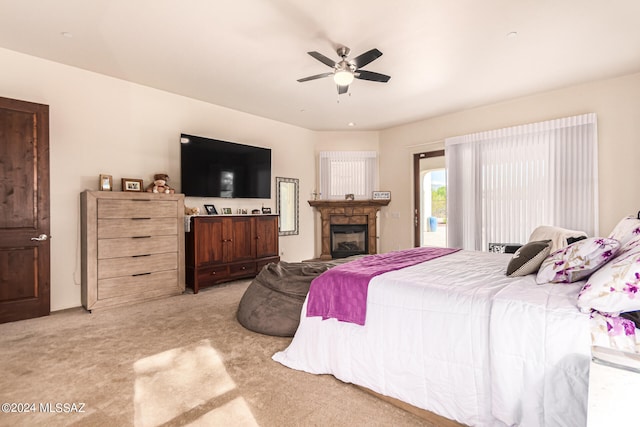 carpeted bedroom featuring access to exterior and ceiling fan