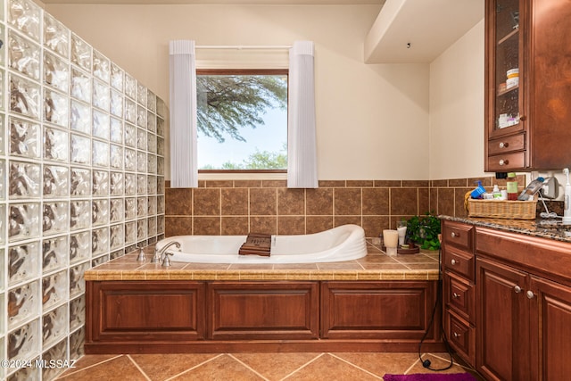 bathroom with vanity, tile patterned flooring, and a bathtub