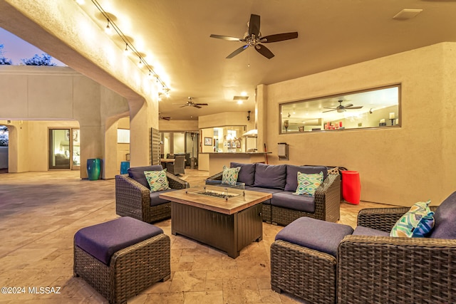 living room featuring track lighting and ceiling fan