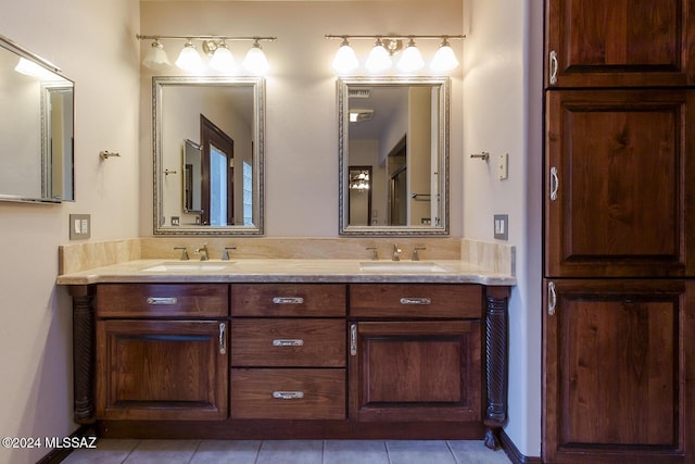 full bathroom featuring double vanity, tile patterned floors, and a sink