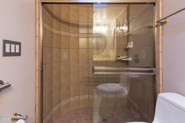 bathroom featuring a shower stall and toilet