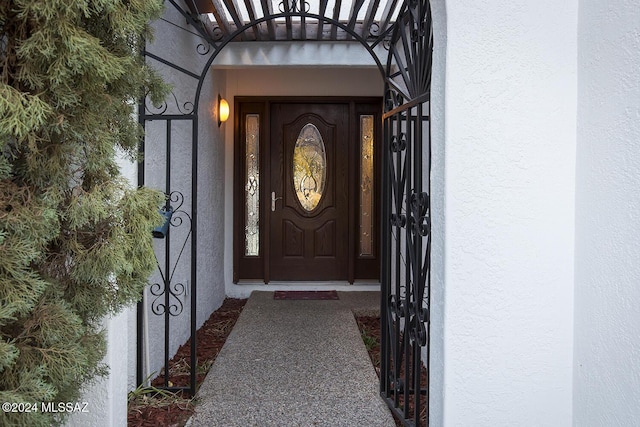 view of exterior entry with stucco siding