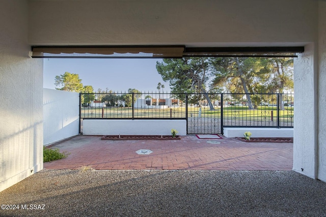 view of gate with a patio and fence