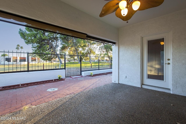 view of patio / terrace with a ceiling fan and fence