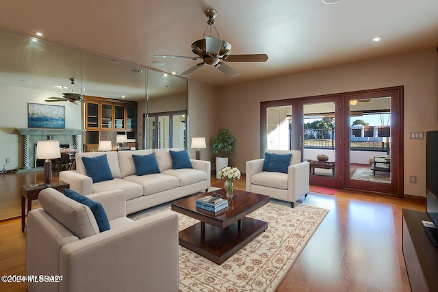 living room featuring light wood-type flooring and ceiling fan