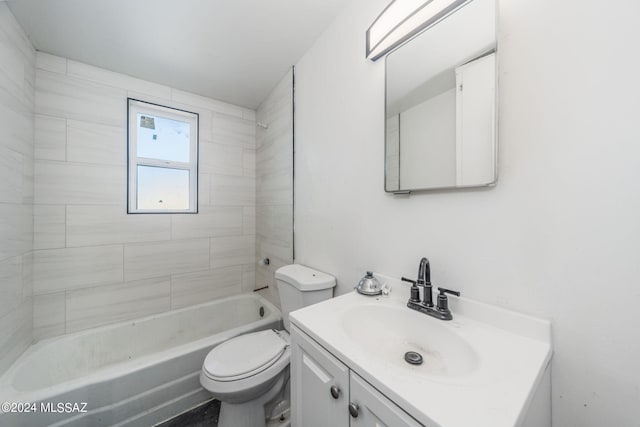 full bathroom featuring toilet, tiled shower / bath, and vanity