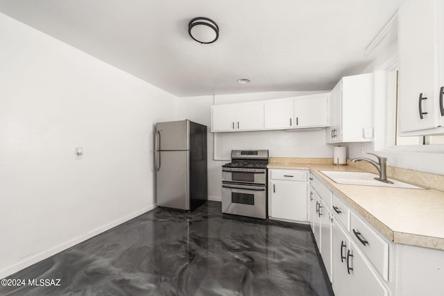 kitchen with white cabinetry, appliances with stainless steel finishes, sink, and vaulted ceiling