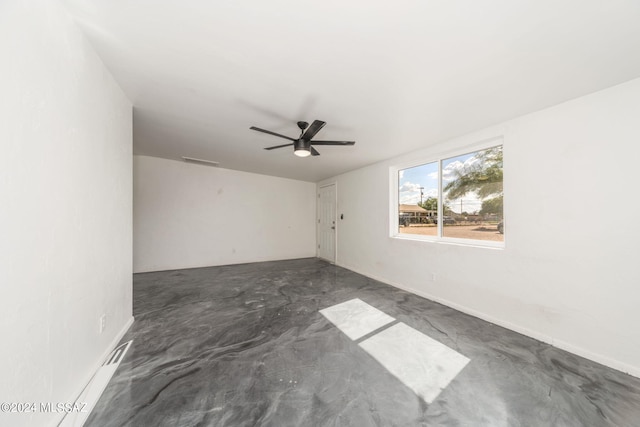 spare room featuring ceiling fan and concrete flooring