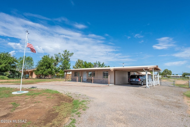 view of front of property featuring covered porch and a carport