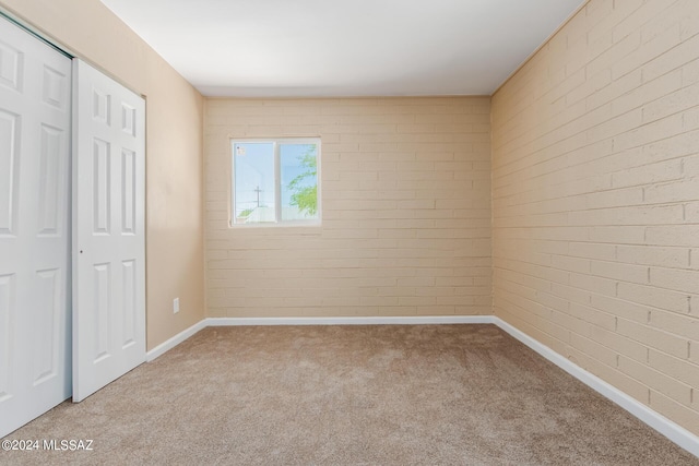 unfurnished bedroom with a closet and light carpet