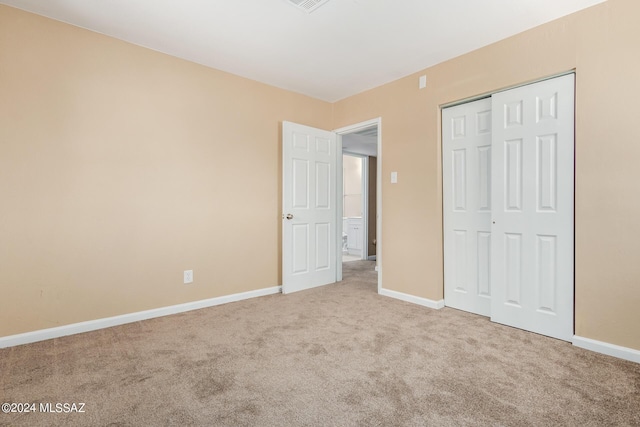 unfurnished bedroom featuring a closet and carpet floors