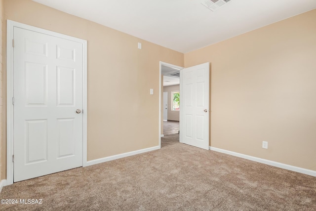 unfurnished bedroom with light carpet