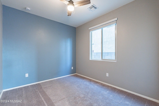 spare room with a ceiling fan, baseboards, visible vents, and carpet flooring