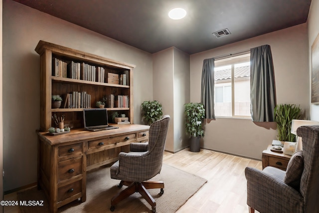 office with visible vents and light wood-style floors