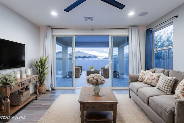 living room with ceiling fan, wood finished floors, visible vents, and recessed lighting