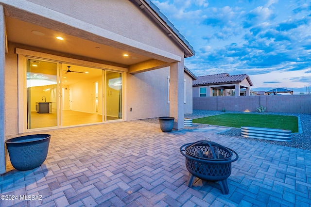 view of patio with a fenced backyard and a fire pit