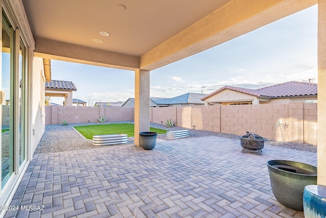 view of patio / terrace featuring an outdoor fire pit and a fenced backyard