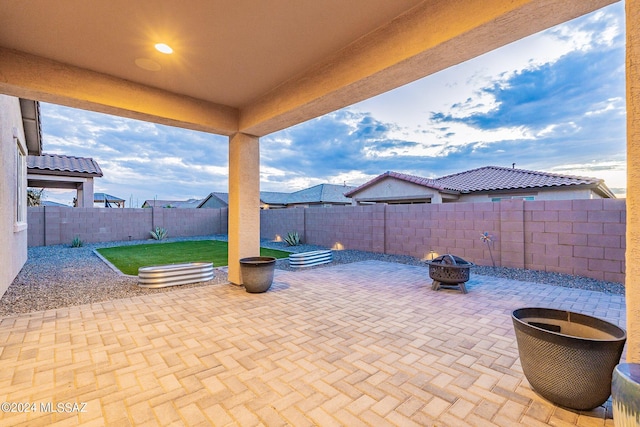 view of patio with a fenced backyard and a fire pit