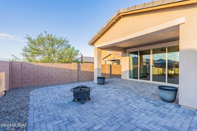 view of patio / terrace featuring an outdoor fire pit and a fenced backyard