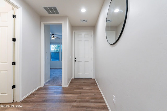 corridor featuring recessed lighting, wood finished floors, visible vents, and baseboards