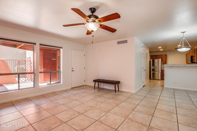 tiled empty room with ceiling fan