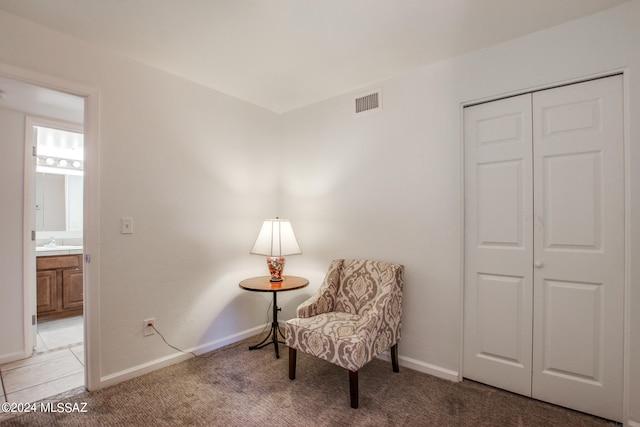 sitting room featuring sink and carpet