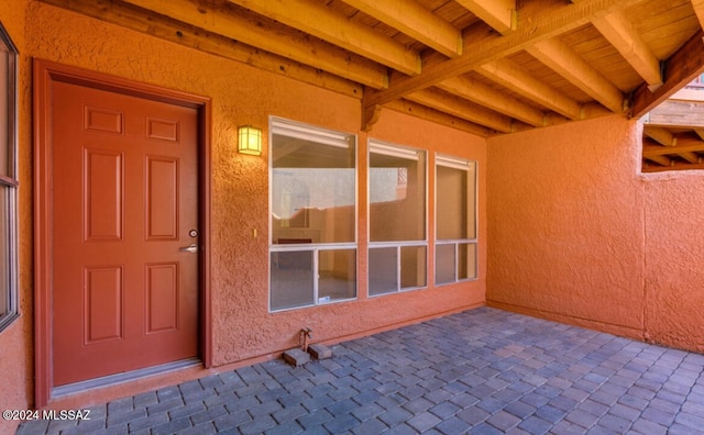 view of exterior entry featuring a patio