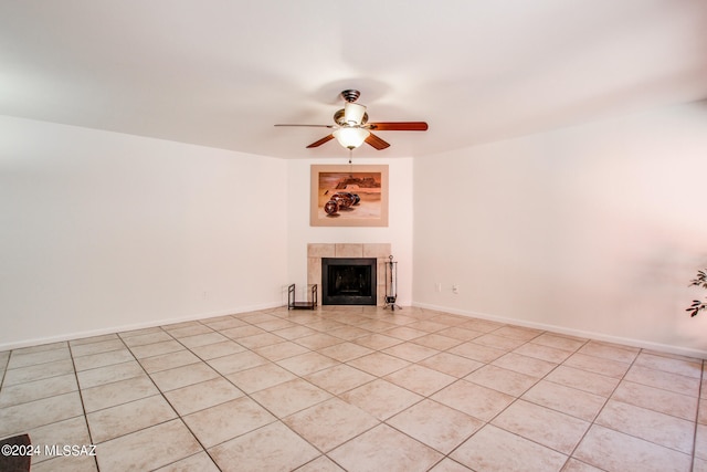 unfurnished living room with light tile patterned floors, a tile fireplace, and ceiling fan