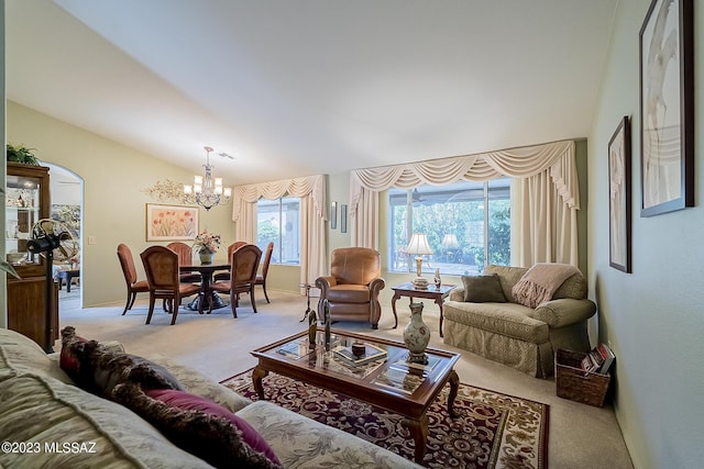 living room featuring a chandelier, lofted ceiling, light colored carpet, and baseboards