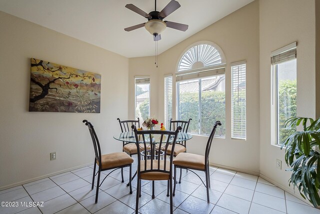 dining space with ceiling fan and light tile patterned floors