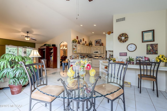 dining room featuring light tile patterned floors, lofted ceiling, visible vents, and ceiling fan with notable chandelier