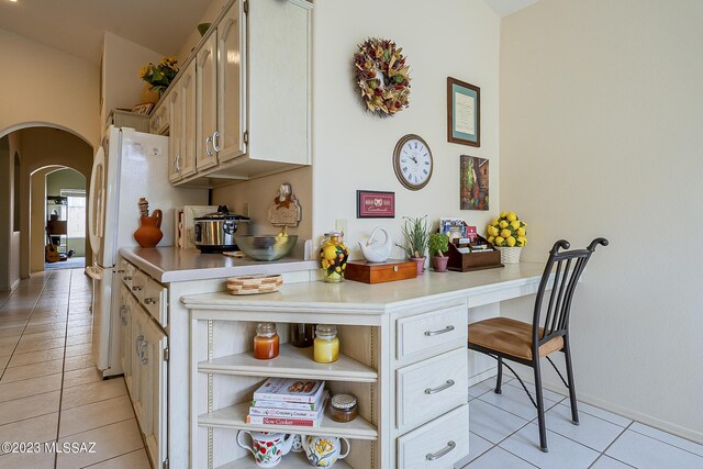 kitchen featuring white refrigerator and light tile patterned floors