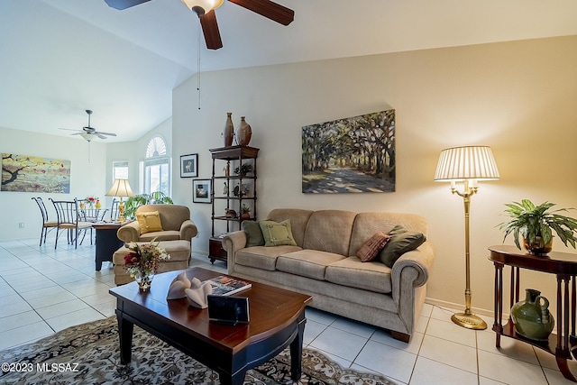 living room with light tile patterned floors, ceiling fan, and vaulted ceiling