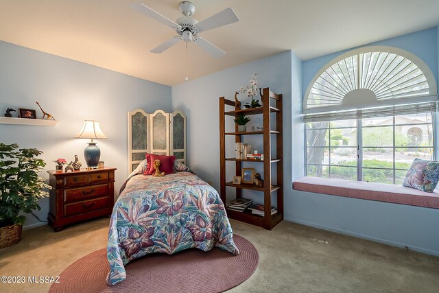 bedroom with ceiling fan and light colored carpet