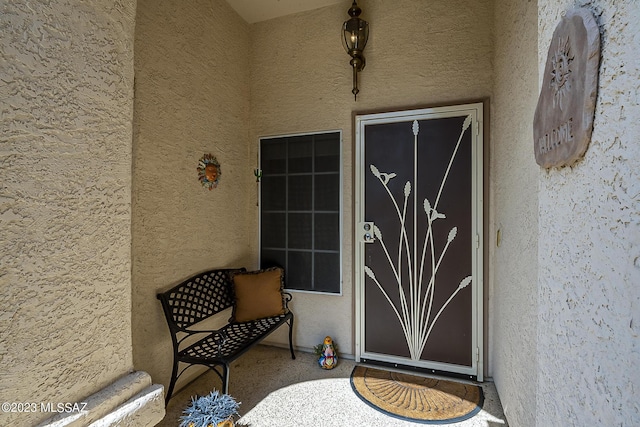 property entrance featuring stucco siding