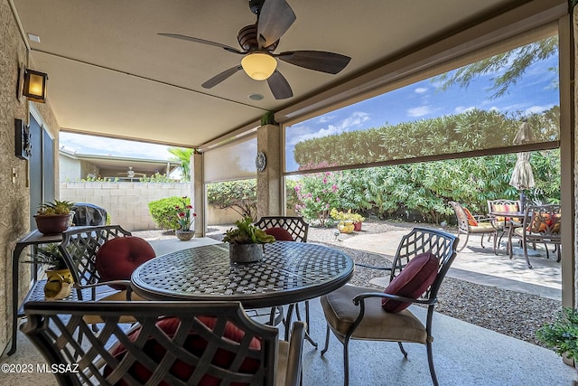 view of patio / terrace featuring fence, a ceiling fan, and outdoor dining space