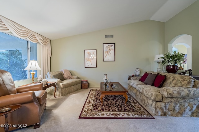 living room with lofted ceiling, carpet floors, and visible vents