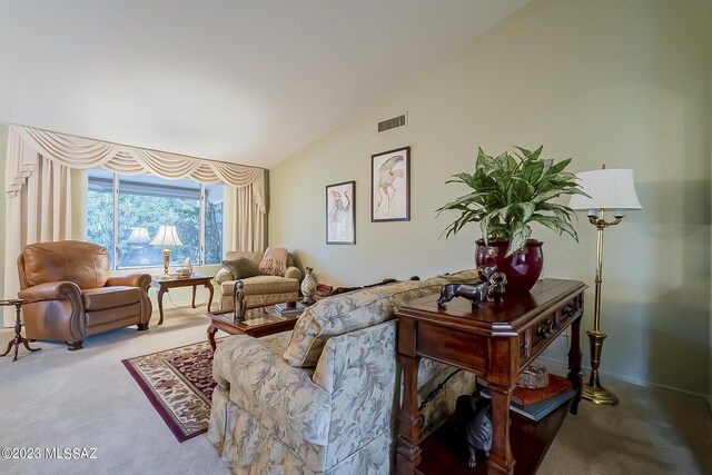 living room featuring vaulted ceiling and carpet flooring