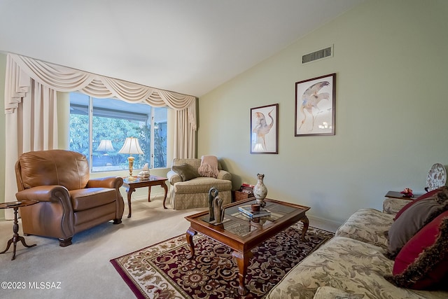 living area featuring lofted ceiling, visible vents, and carpet floors