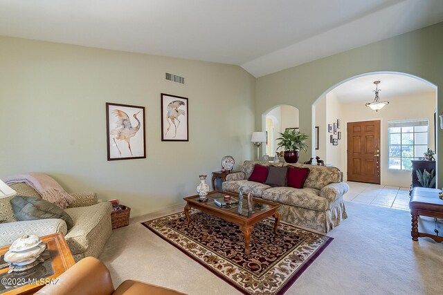 carpeted living room with vaulted ceiling