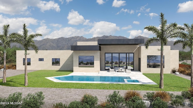 rear view of house featuring a lawn, a patio area, and a mountain view