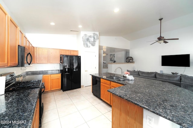 kitchen with ceiling fan, lofted ceiling, sink, black appliances, and dark stone counters