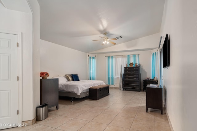 bedroom featuring a ceiling fan, lofted ceiling, visible vents, and light tile patterned floors