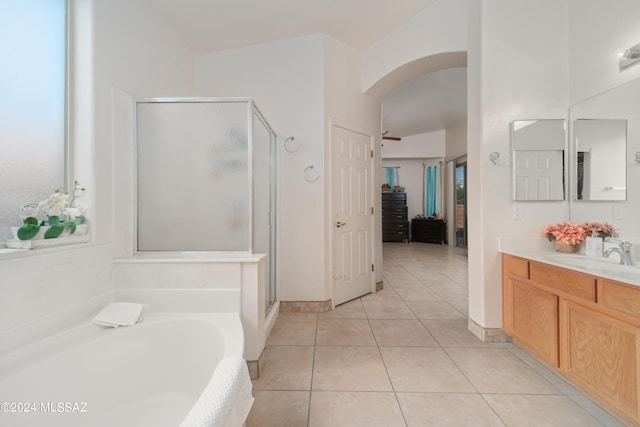 bathroom featuring vaulted ceiling, vanity, separate shower and tub, ceiling fan, and tile patterned floors